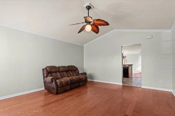a living room with furniture and a ceiling fan