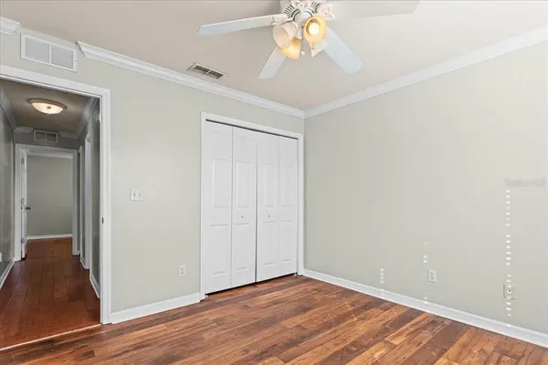 a view of an empty room with wooden floor