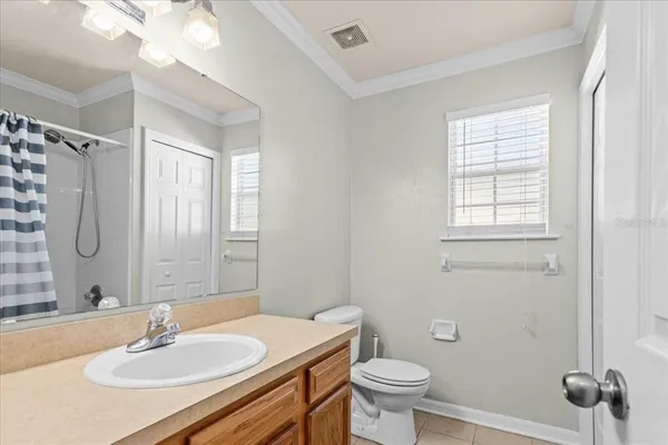 a bathroom with a sink toilet a mirror and shower
