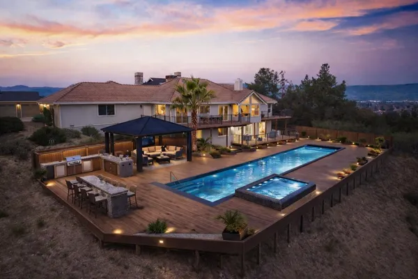 an aerial view of a house with outdoor space patio and lake view
