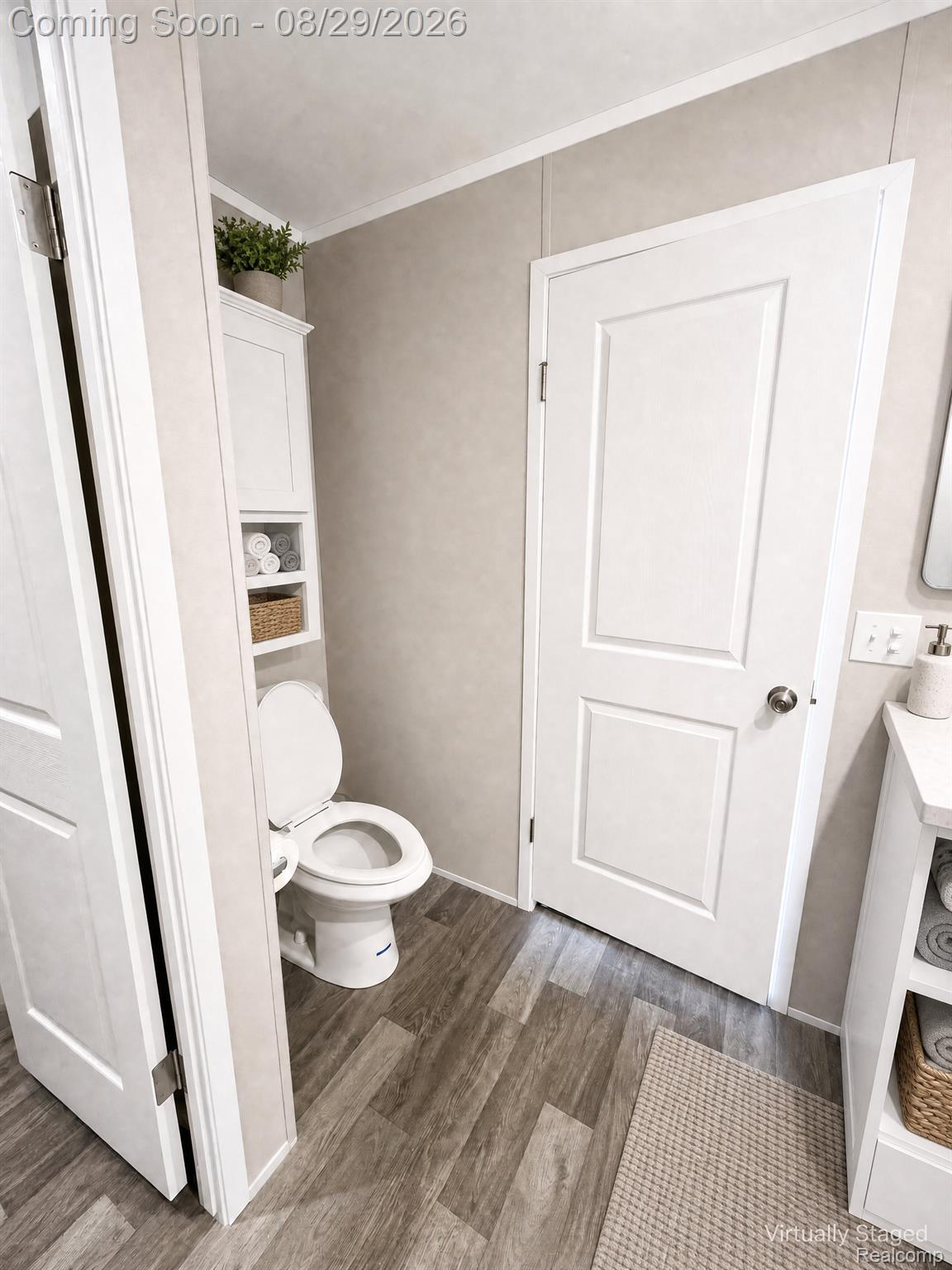 46000 Geddes Road, Unit 520 Canton, MI 48188 - Photo 23 of 29 Wood-finish plank flooring, neutral wall paneling, built-in storage cabinetry, and a white toilet