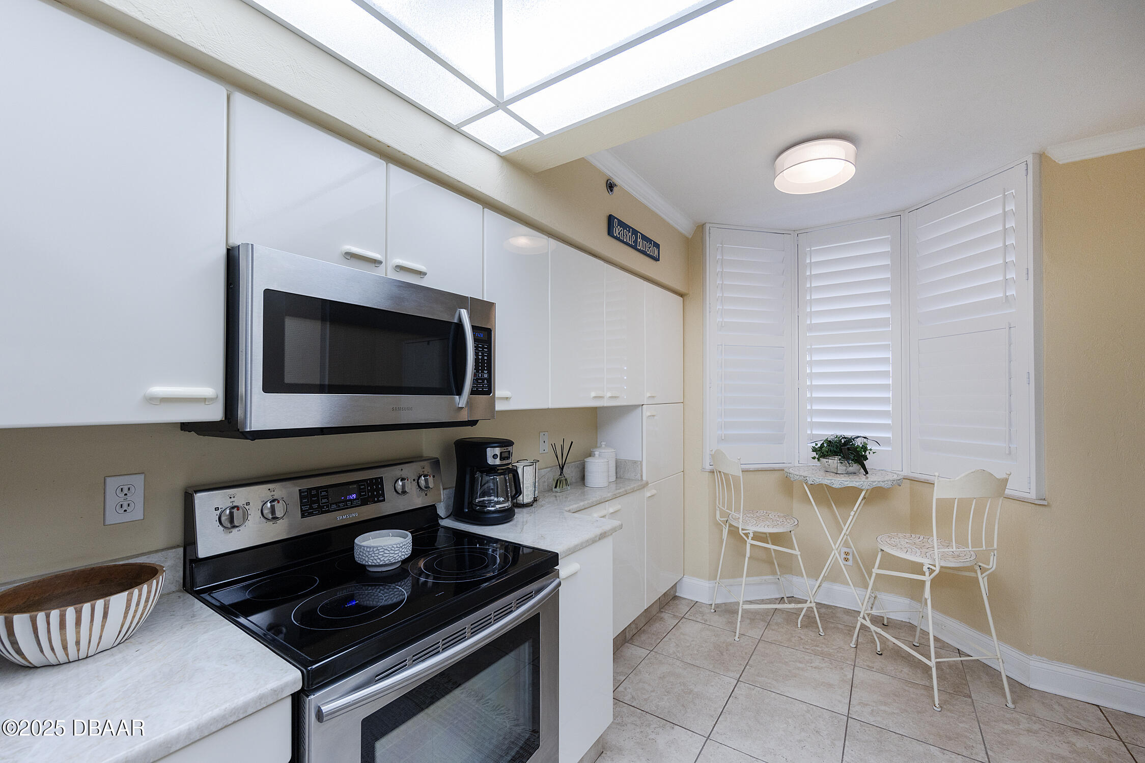 4545 South Atlantic Avenue, Unit 3704 Ponce Inlet, FL 32127 - Photo 13 of 66 a kitchen with a stove and a microwave