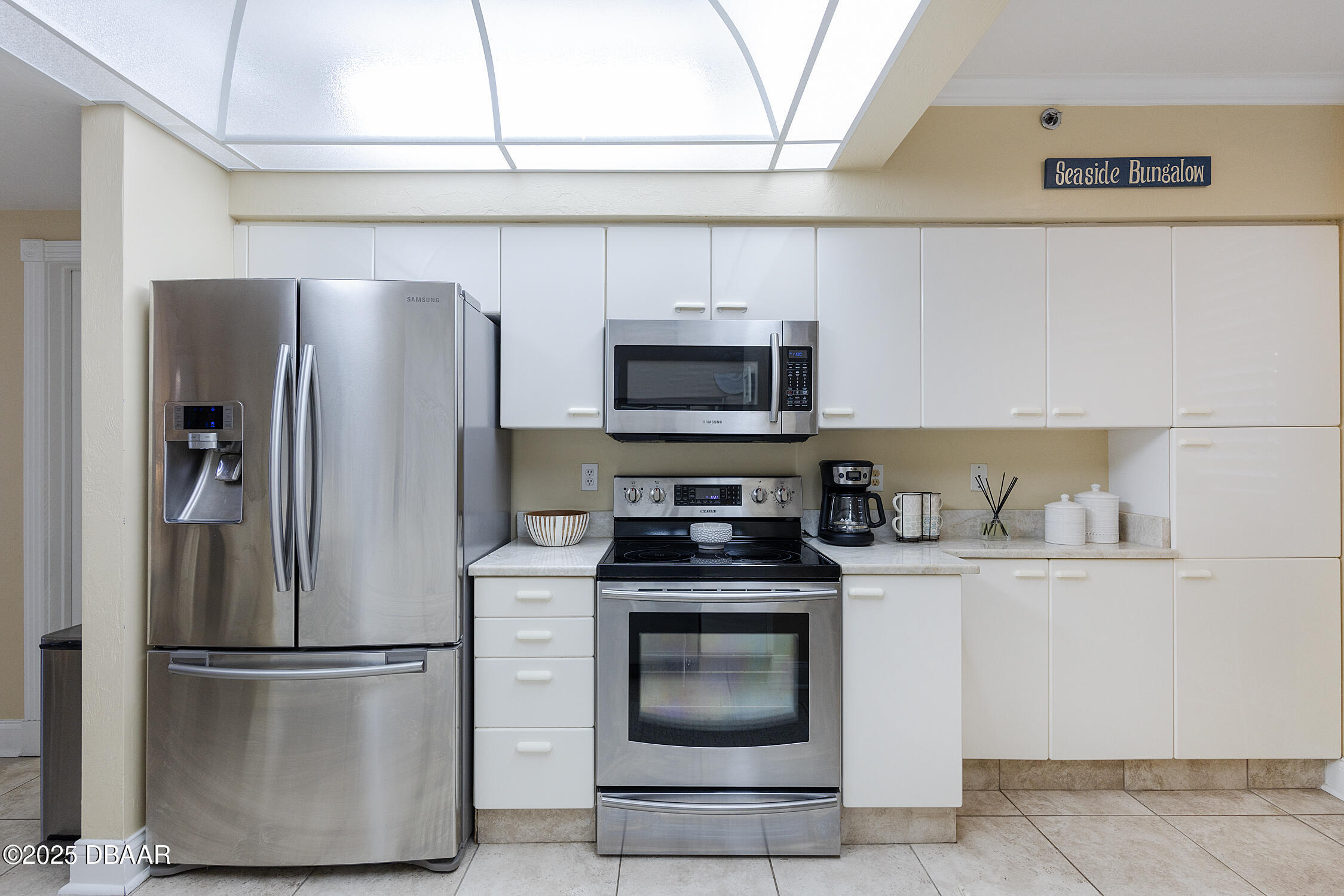 4545 South Atlantic Avenue, Unit 3704 Ponce Inlet, FL 32127 - Photo 15 of 66 a kitchen with stainless steel appliances a refrigerator stove and microwave