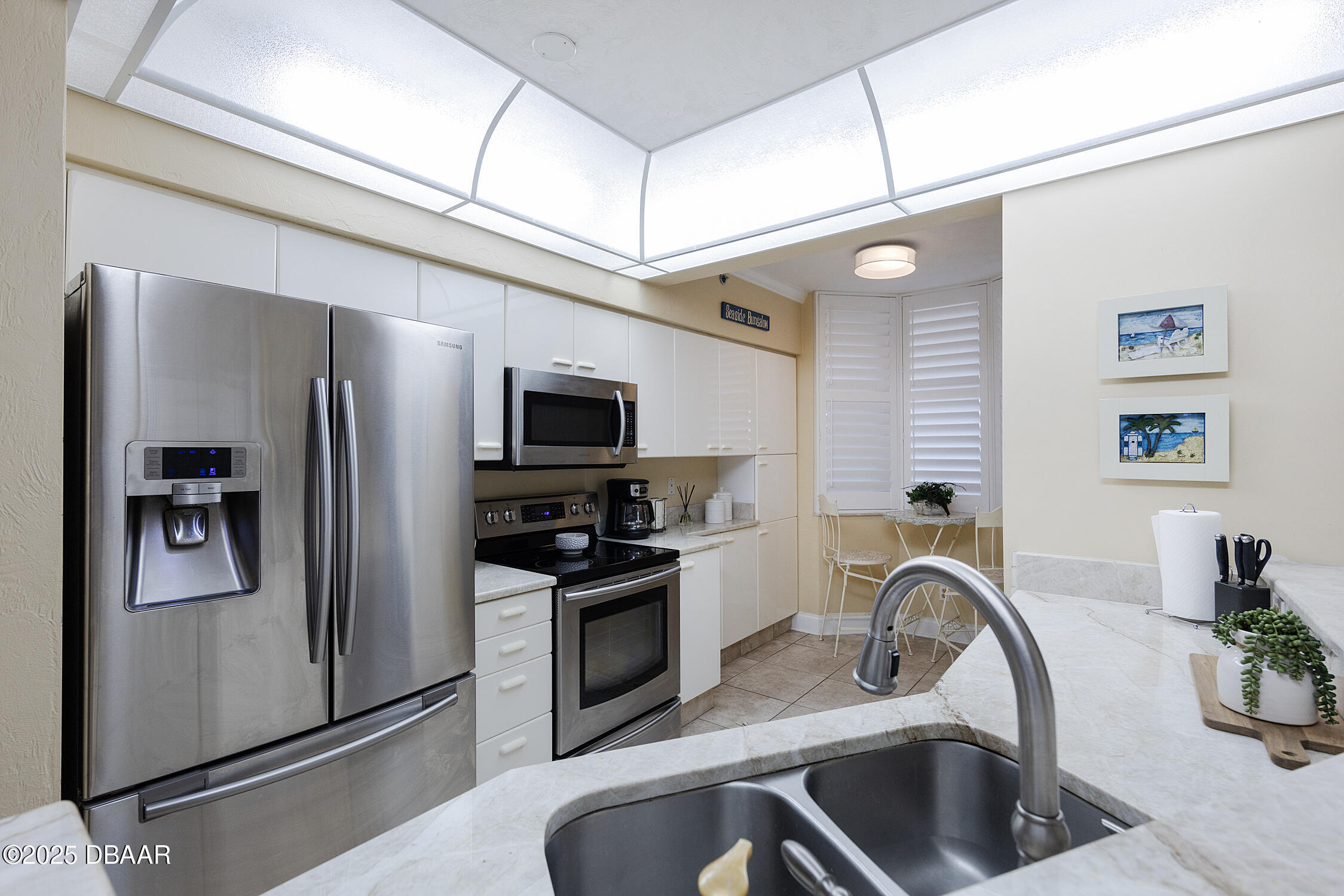 4545 South Atlantic Avenue, Unit 3704 Ponce Inlet, FL 32127 - Photo 16 of 66 a kitchen with stainless steel appliances a refrigerator a sink a stove and cabinets