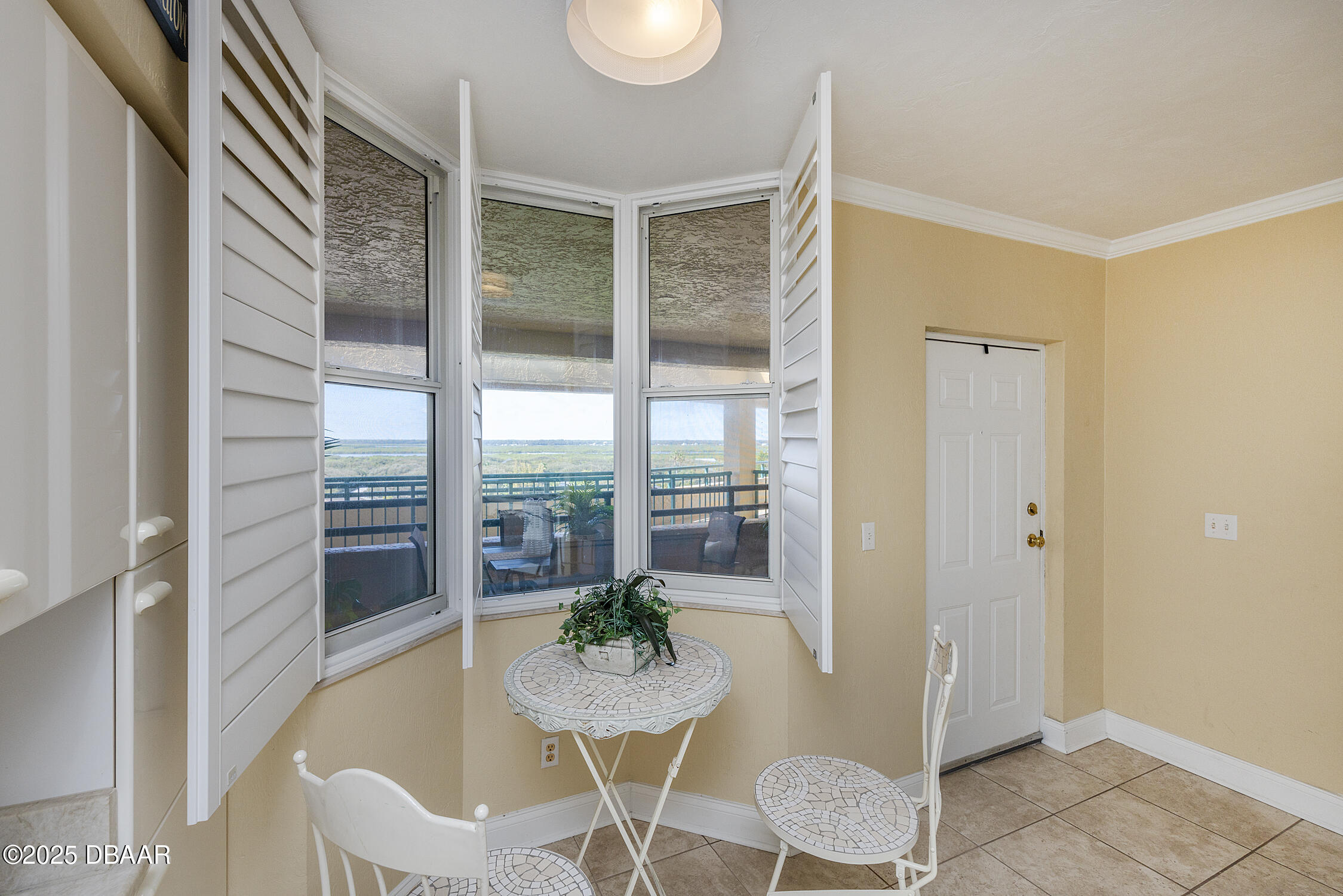 4545 South Atlantic Avenue, Unit 3704 Ponce Inlet, FL 32127 - Photo 19 of 66 a view of a dining room with furniture window and wooden floor