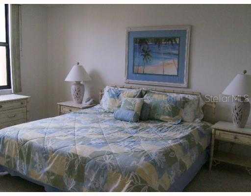 8764 Midnight Pass Road, Unit A403 Sarasota, FL 34242 - Photo 8 of 10 Master Bedroom - Main bedroom with ensuite bath, walk in closet, separate vanity area, shower and Full gulf views