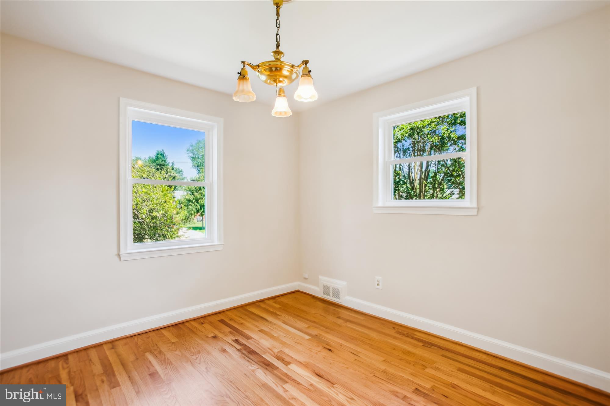 5909 Frederick Street Springfield, VA 22150 - Photo 14 of 62 a view of an empty room with wooden floor and a window