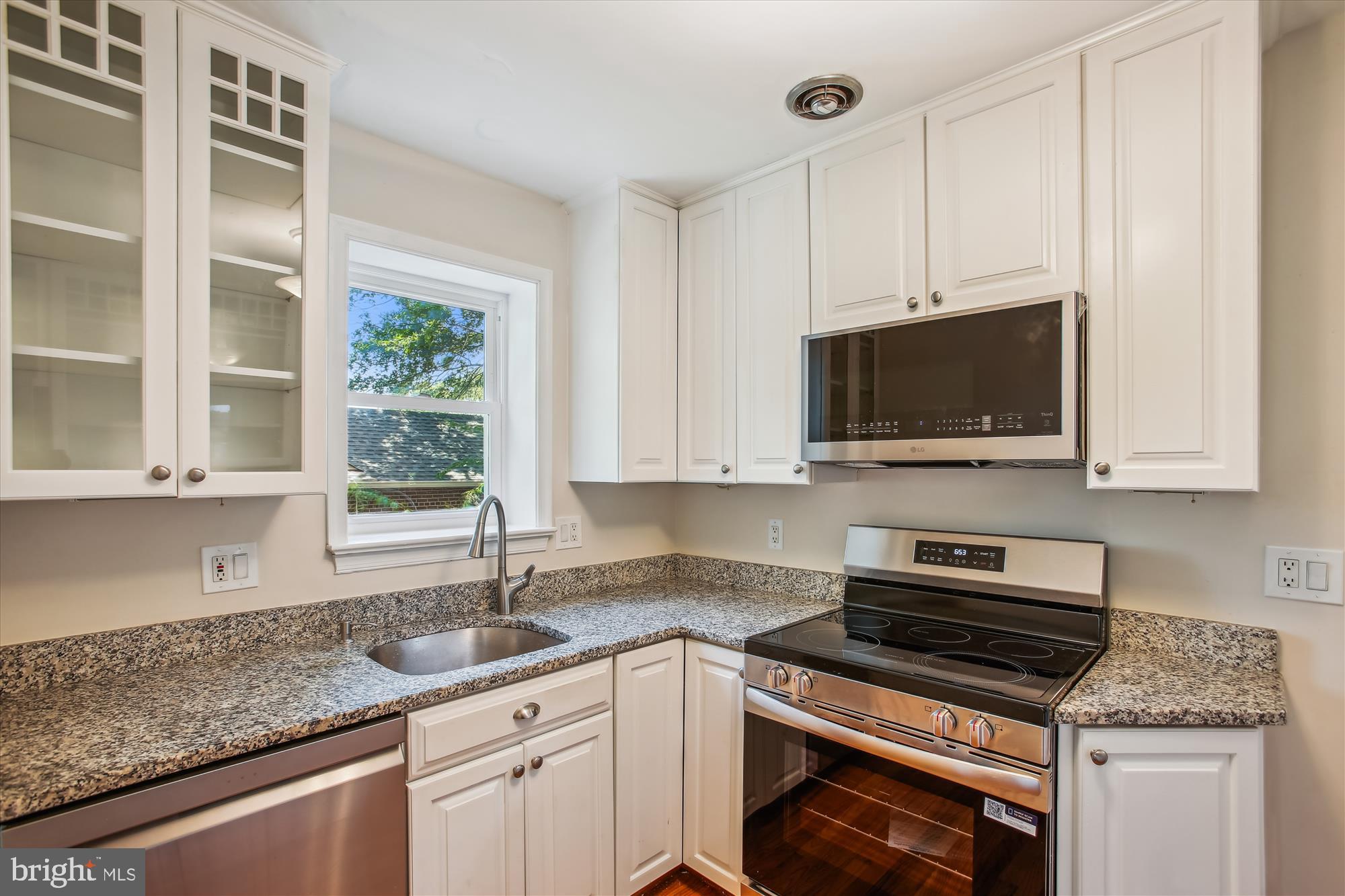 5909 Frederick Street Springfield, VA 22150 - Photo 19 of 62 a kitchen with stainless steel appliances granite countertop a sink stove and microwave