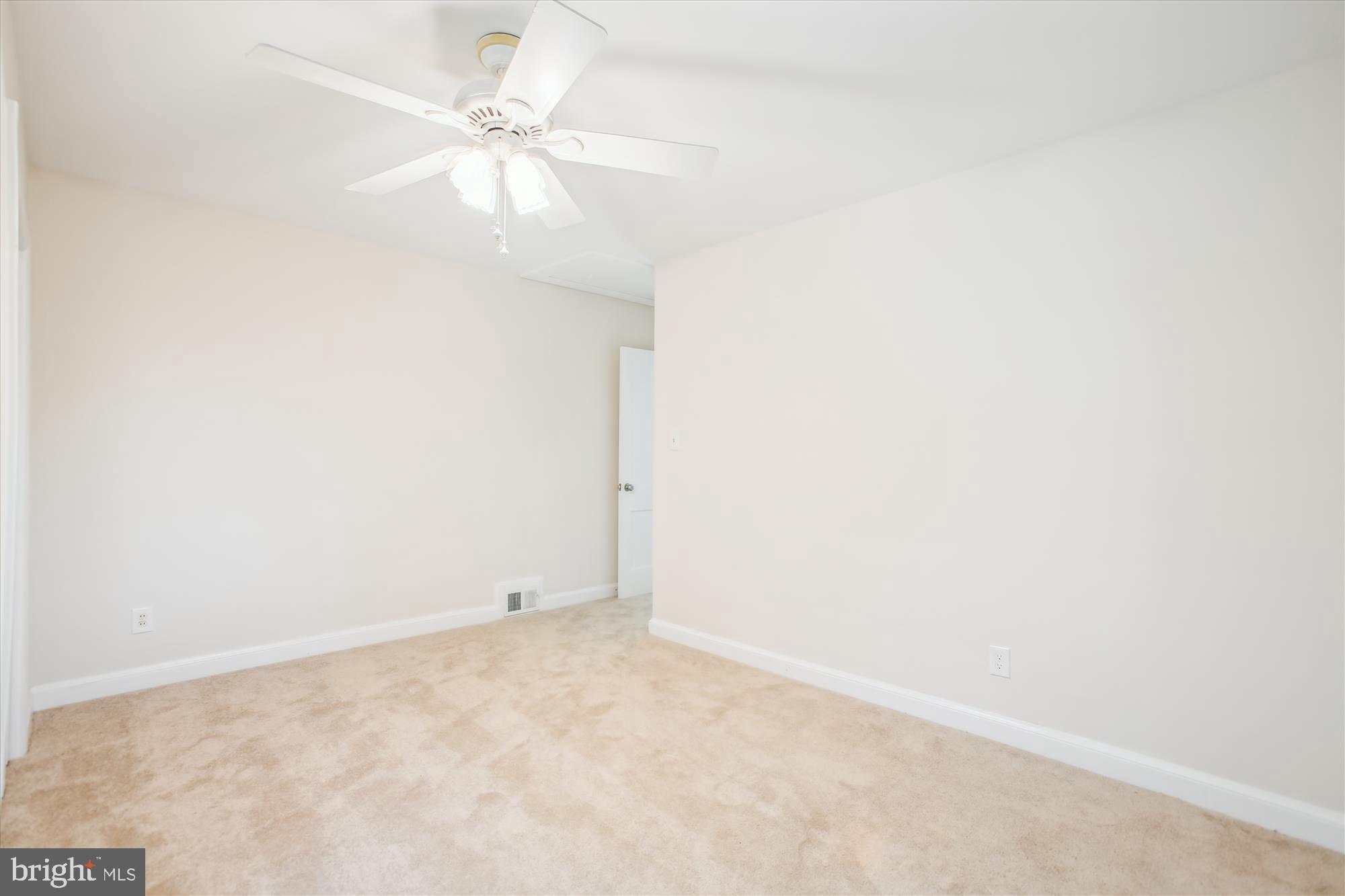 5909 Frederick Street Springfield, VA 22150 - Photo 29 of 62 an empty room with a ceiling fan and carpet