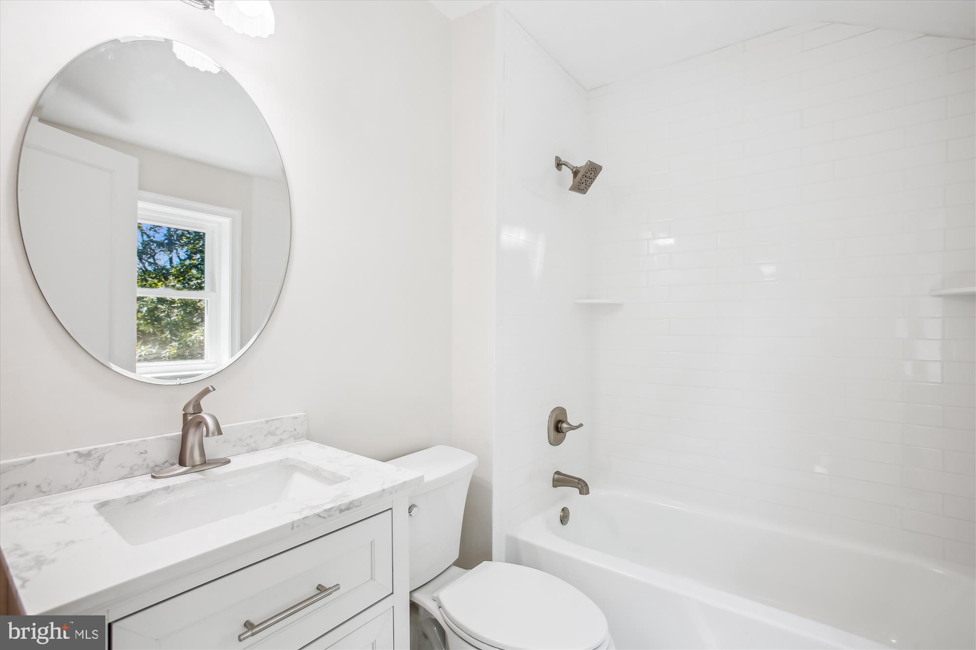 5909 Frederick Street Springfield, VA 22150 - Photo 34 of 62 a bathroom with a sink toilet and shower