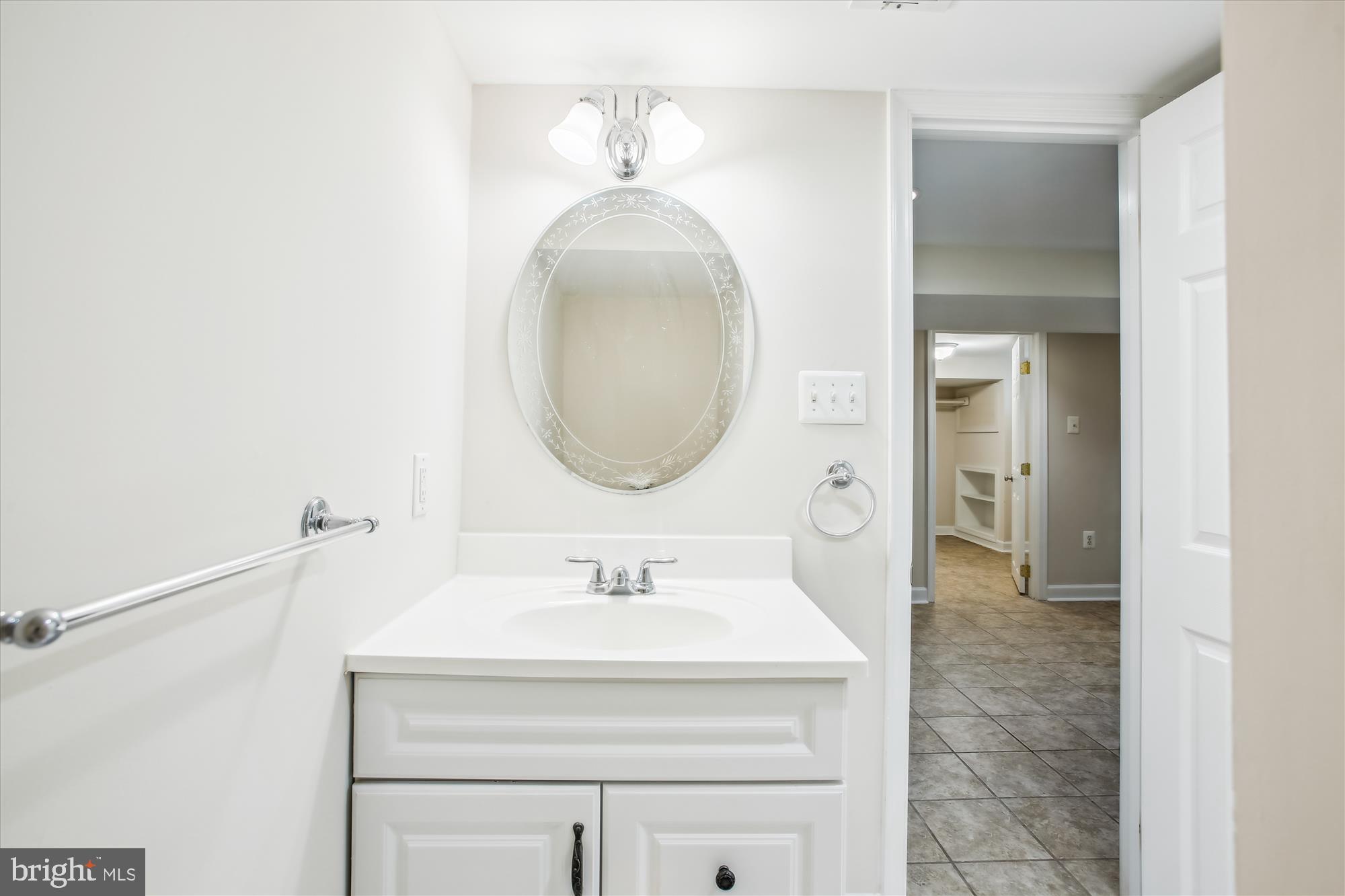 5909 Frederick Street Springfield, VA 22150 - Photo 42 of 62 a bathroom with a sink and a mirror