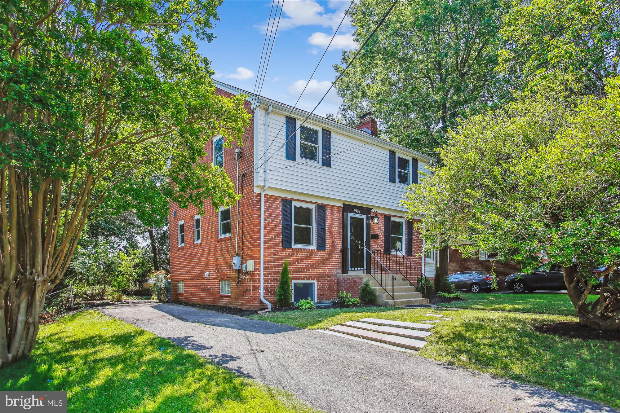 5909 Frederick Street Springfield, VA 22150 - Photo 47 of 62 a front view of a house with a yard and trees