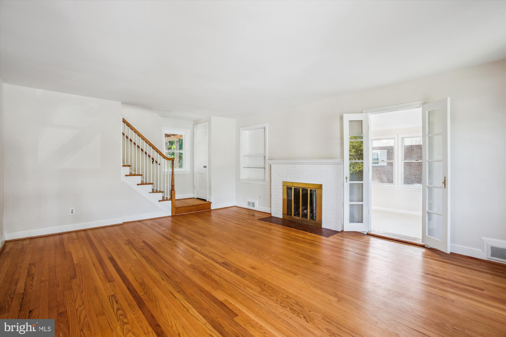 5909 Frederick Street Springfield, VA 22150 - Photo 5 of 62 a view of empty room with wooden floor and fireplace