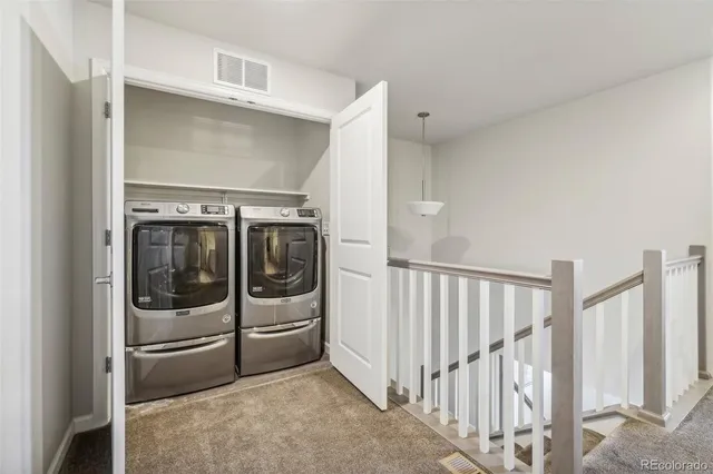 a utility room with wooden floor and white doors