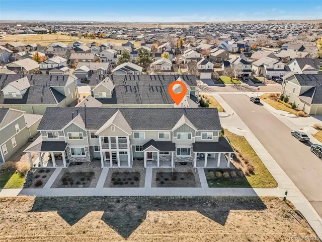an aerial view of a house with a big yard and large tree