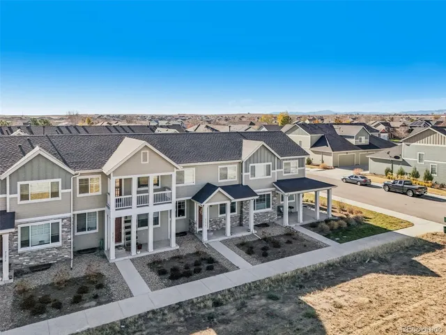 a front view of a house with yard and trees