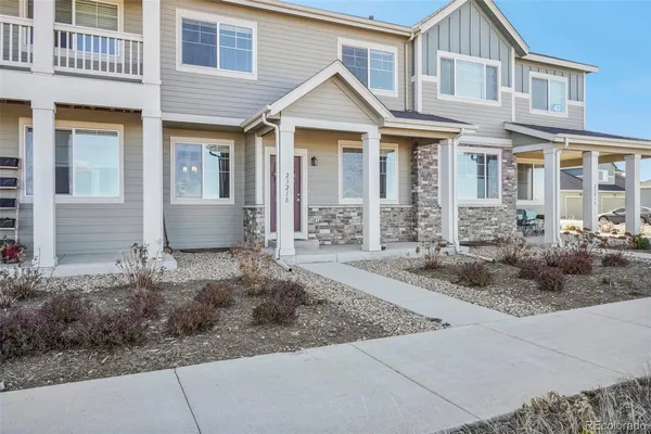 a view of a white house next to a yard