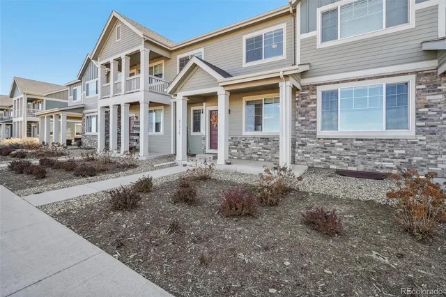 a front view of a house with garage and yard