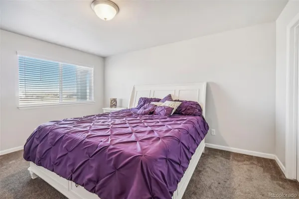 a bed sitting in a bedroom next to a window