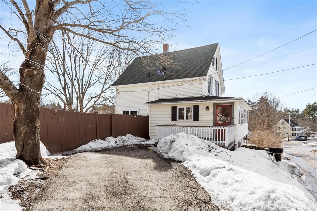 a front view of a house with a yard covered in snow