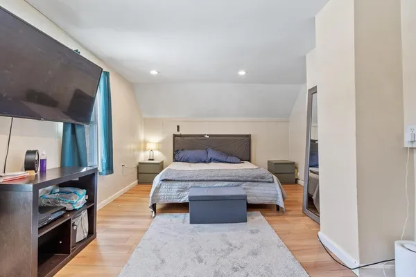 a bedroom with a bed and a mirror