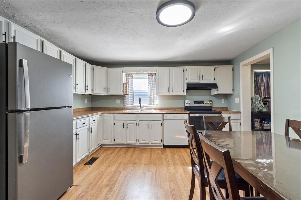 7 Jackson Street Gardner, MA 01440 - Photo 5 of 24 a kitchen with stainless steel appliances granite countertop a refrigerator sink and cabinets