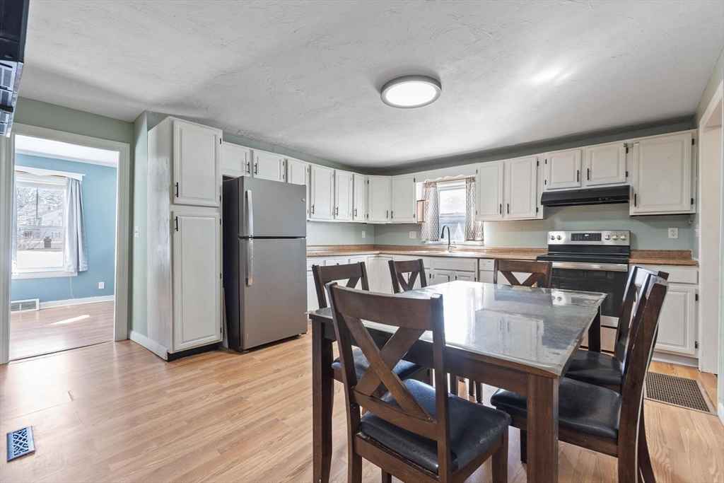 7 Jackson Street Gardner, MA 01440 - Photo 6 of 24 a kitchen with stainless steel appliances granite countertop a dining table chairs refrigerator and sink