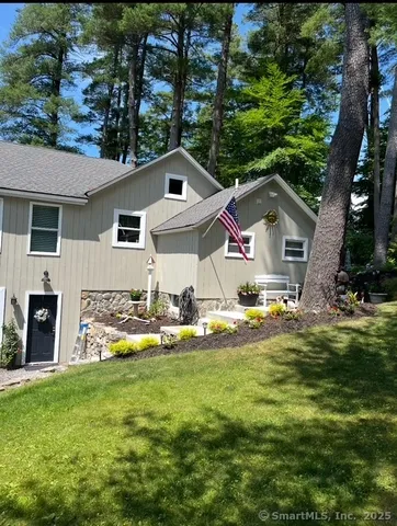a front view of house with yard and green space