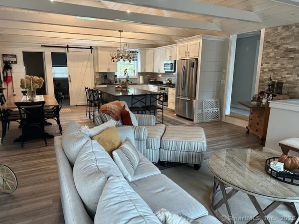 a living room with furniture fireplace and a flat screen tv