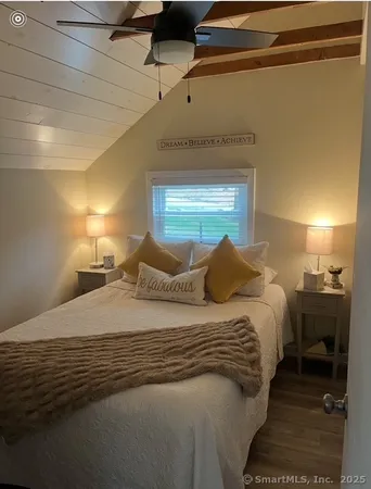 a bedroom with a bed and a lamp