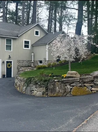 a front view of a house with a garden