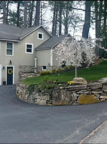 a front view of a house with a garden