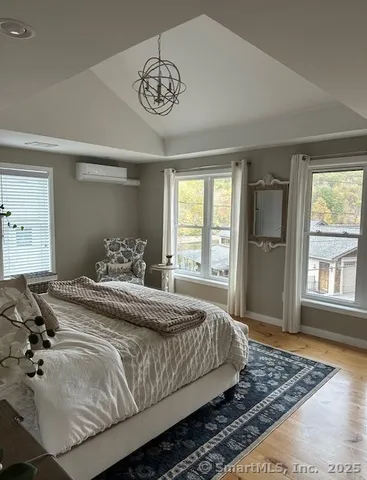a bedroom with a large bed and a window