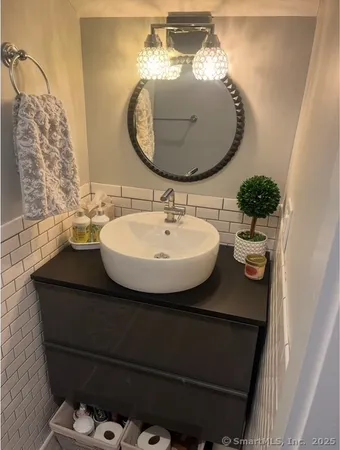 a bathroom with a sink and mirror