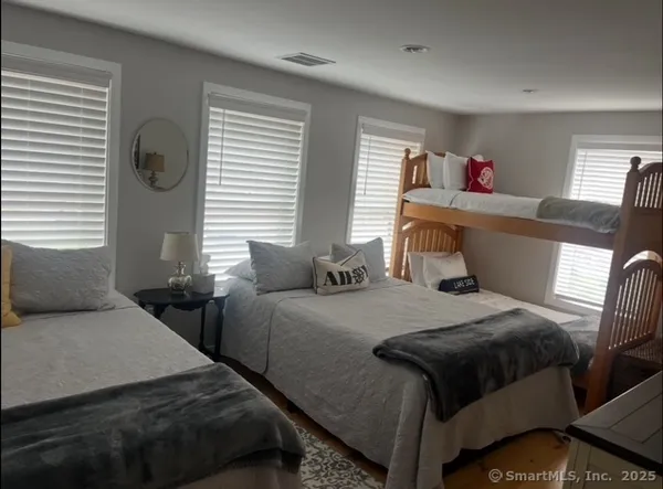 a bedroom with two beds and a window