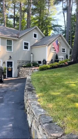 a front view of house with yard and outdoor seating