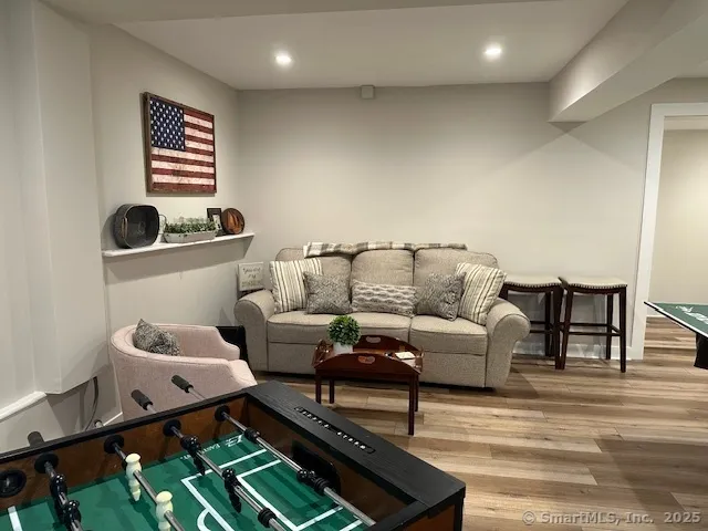 a living room with furniture and wooden floor