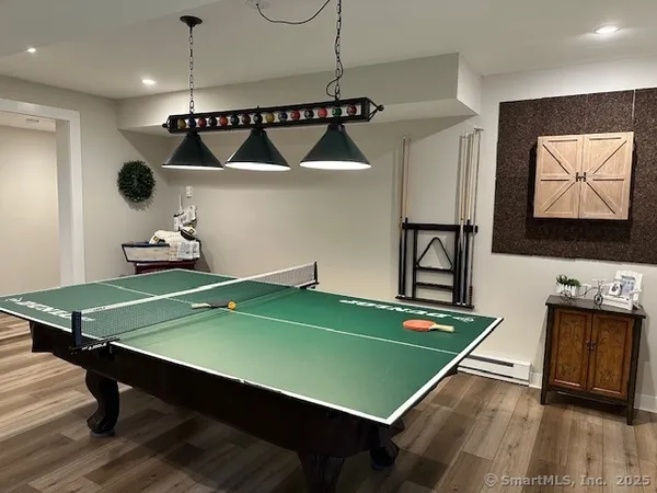 a room with pool table and windows