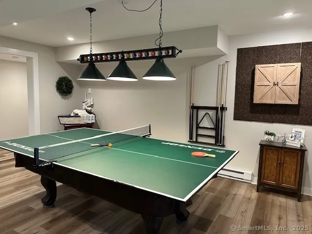 a room with pool table and windows