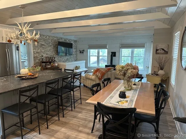 a view of a dining room with furniture and a chandelier
