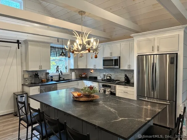 a kitchen with a dining table and chairs in it