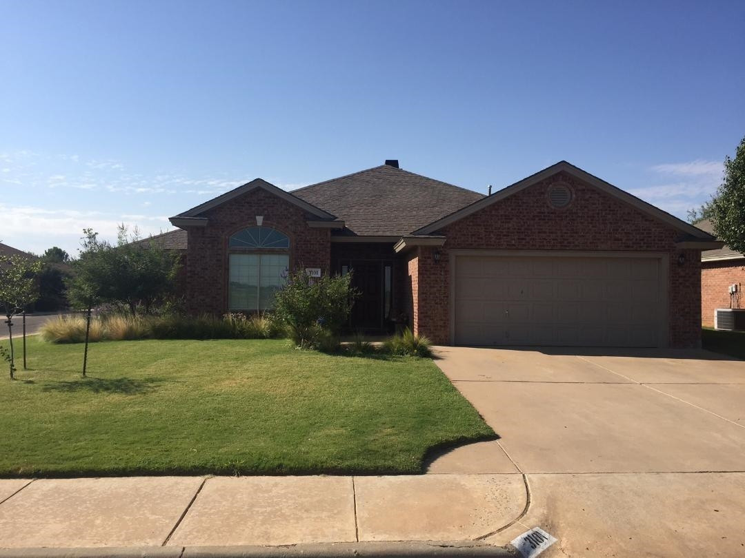 3101 103rd Street Lubbock, TX 79423 - Photo 2 of 10 a house with green field in front of it