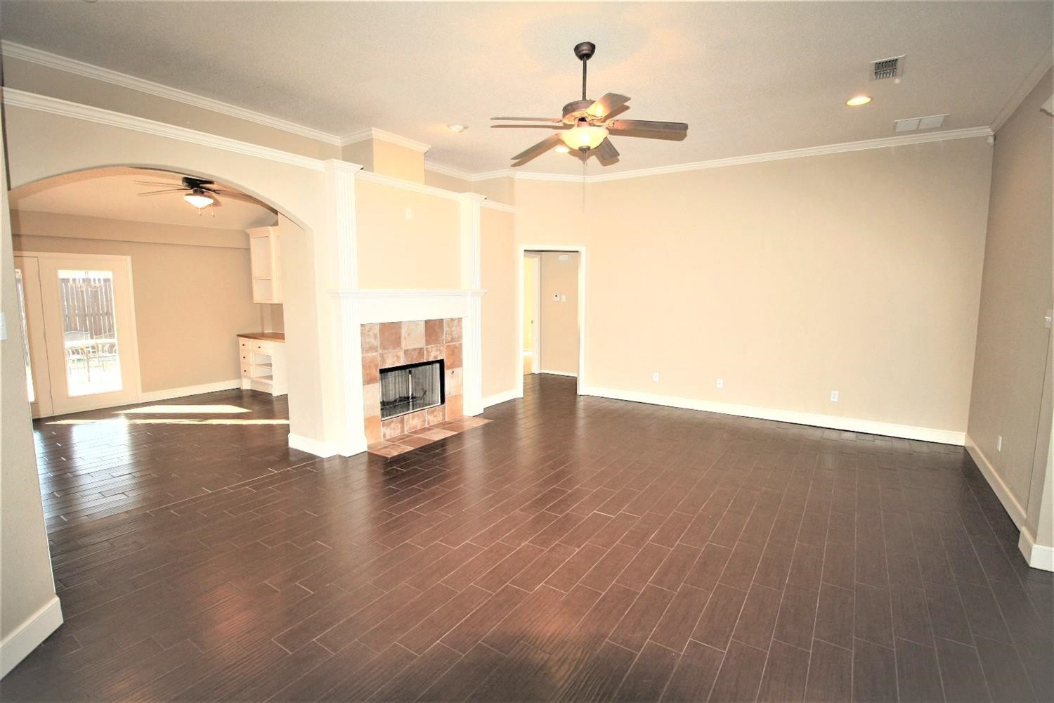 3101 103rd Street Lubbock, TX 79423 - Photo 4 of 10 a view of a livingroom with wooden floor and a ceiling fan
