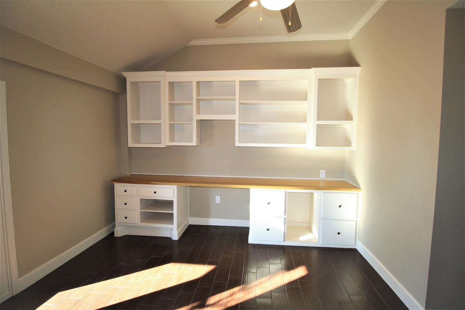3101 103rd Street Lubbock, TX 79423 - Photo 6 of 10 a view of an empty room with wooden floor and a window