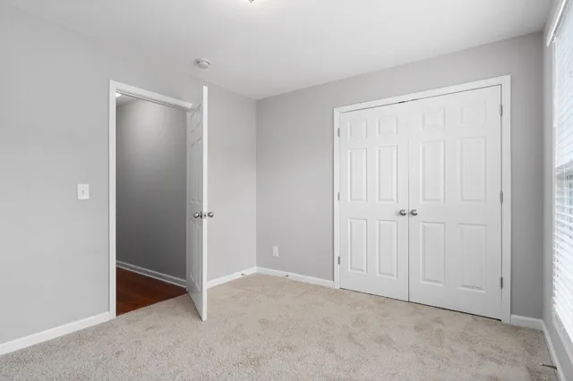 a view of an empty room with closet area