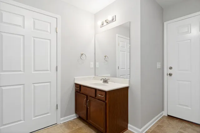 a bathroom with a sink a vanity and a mirror