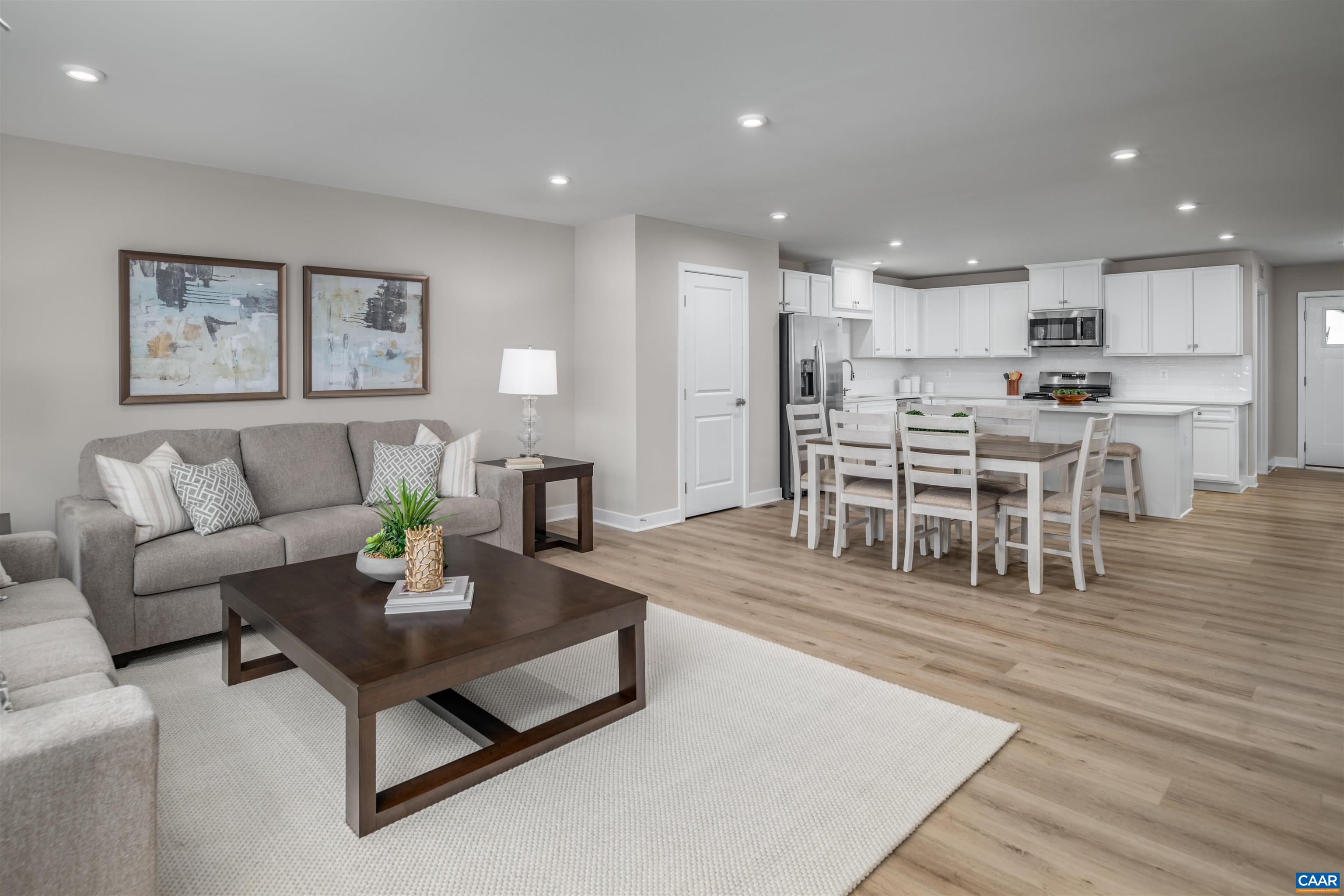 5137 Lazy Branch Lane Keswick, VA 22947 - Photo 2 of 13 a living room with furniture and a dining table with wooden floor