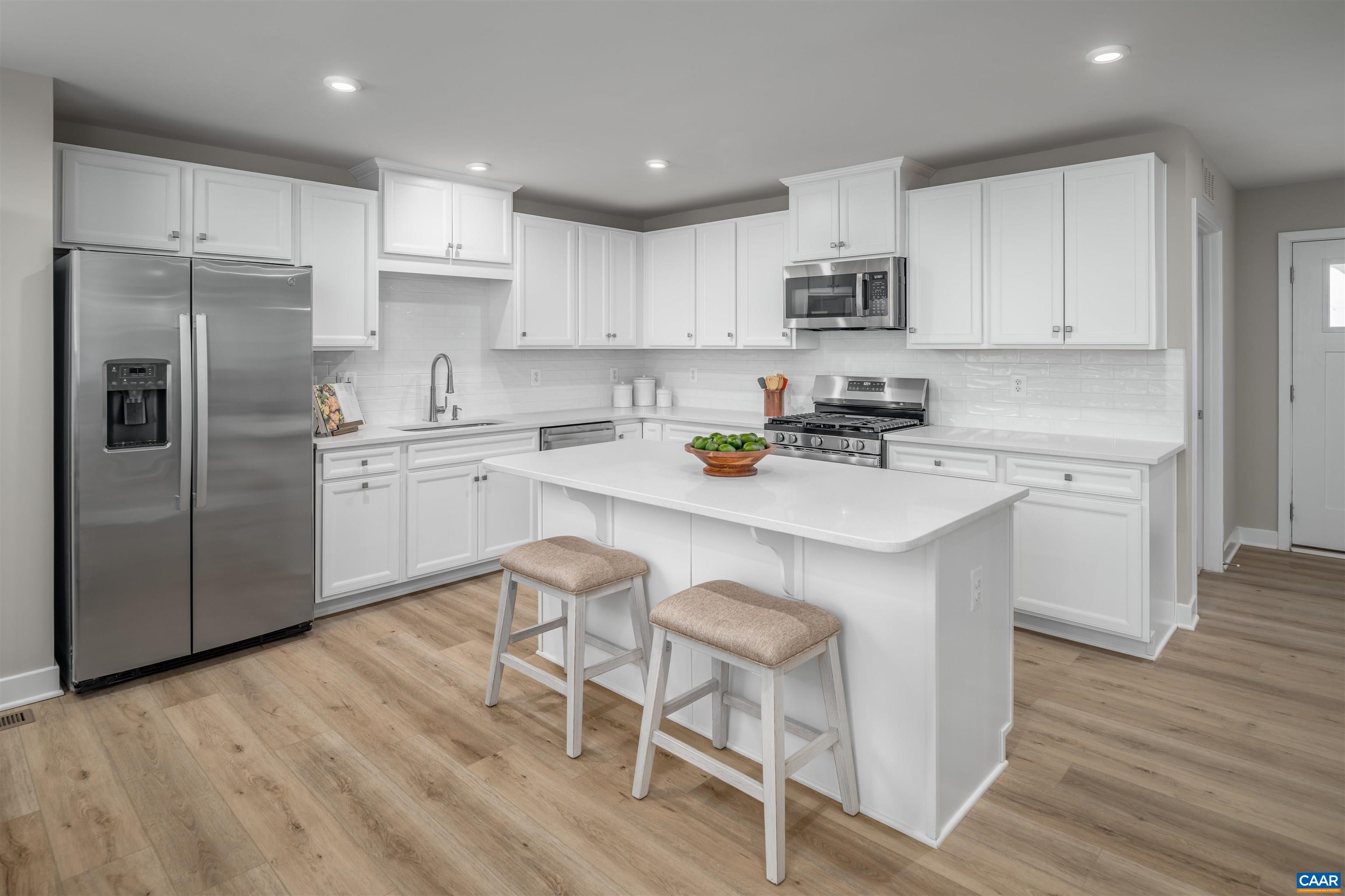 5137 Lazy Branch Lane Keswick, VA 22947 - Photo 3 of 13 a kitchen with a sink a refrigerator and white cabinets