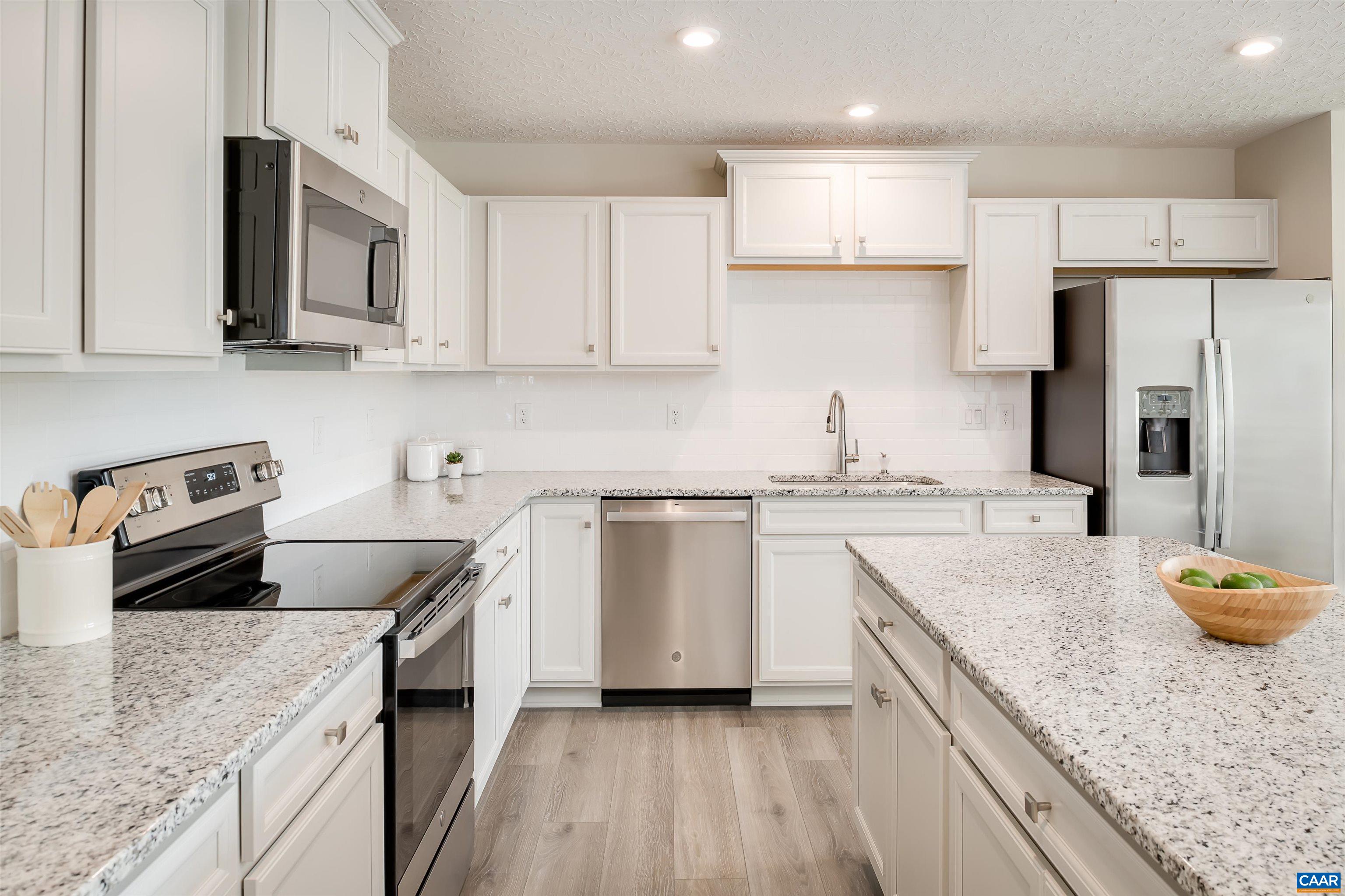 5137 Lazy Branch Lane Keswick, VA 22947 - Photo 4 of 13 a kitchen with granite countertop stainless steel appliances cabinets a sink and a counter top space