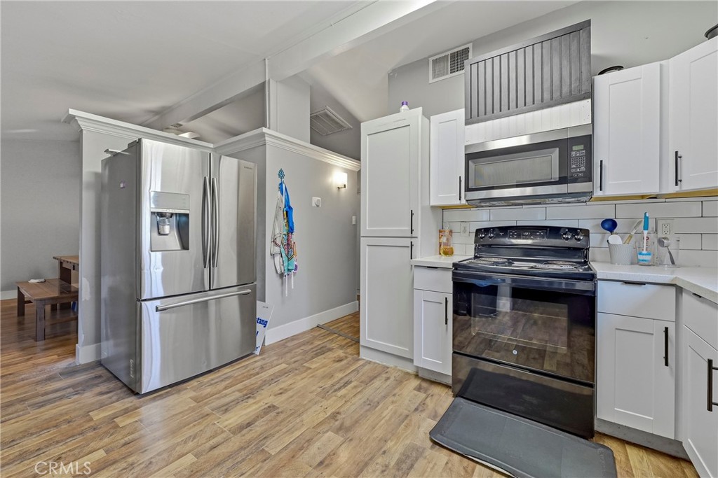 2690 Hawthorne Avenue Merced, CA 95340 - Photo 16 of 36 a kitchen with stainless steel appliances a refrigerator stove and microwave